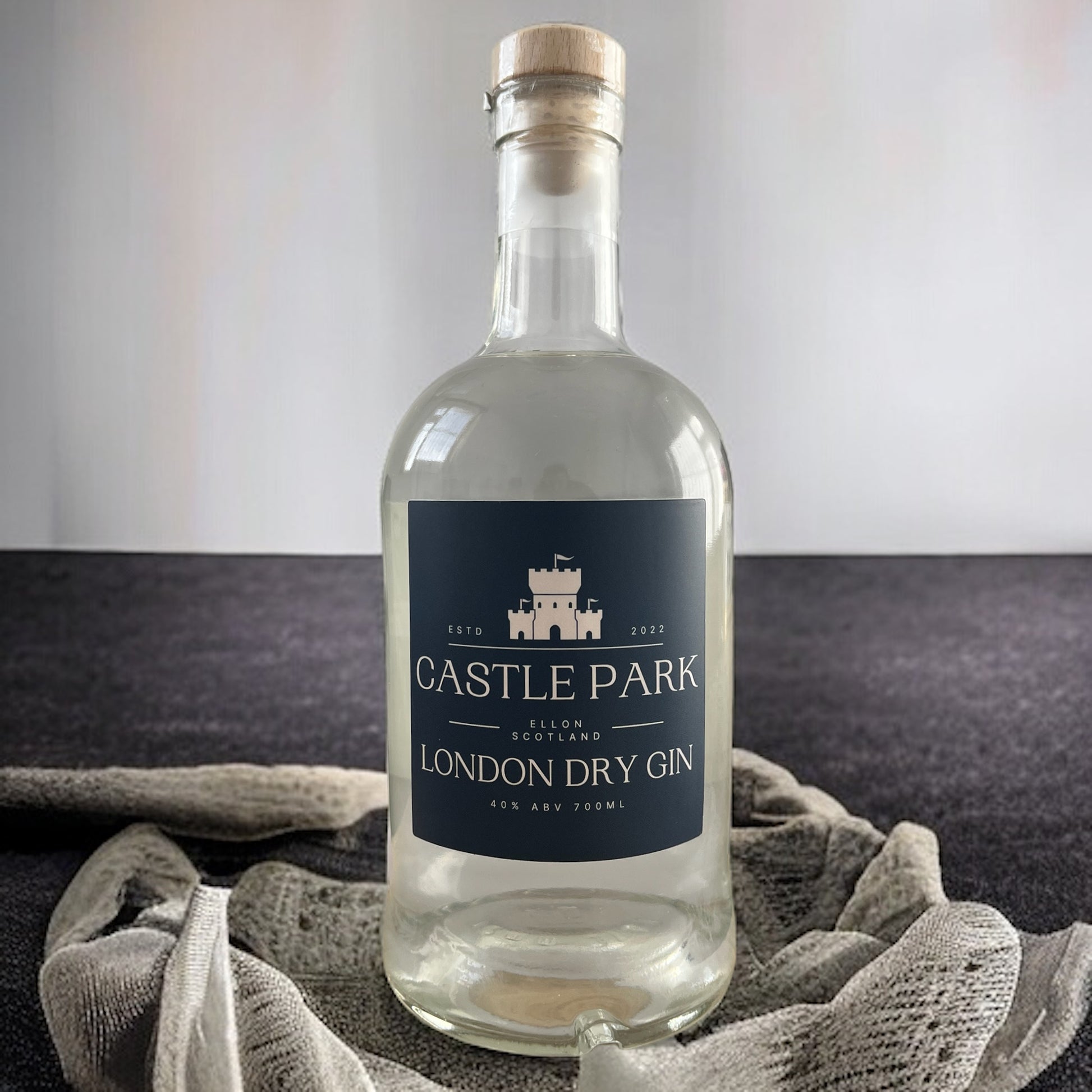 Castle Park London Dry Gin 40% 700ml on rocks with white and grey background