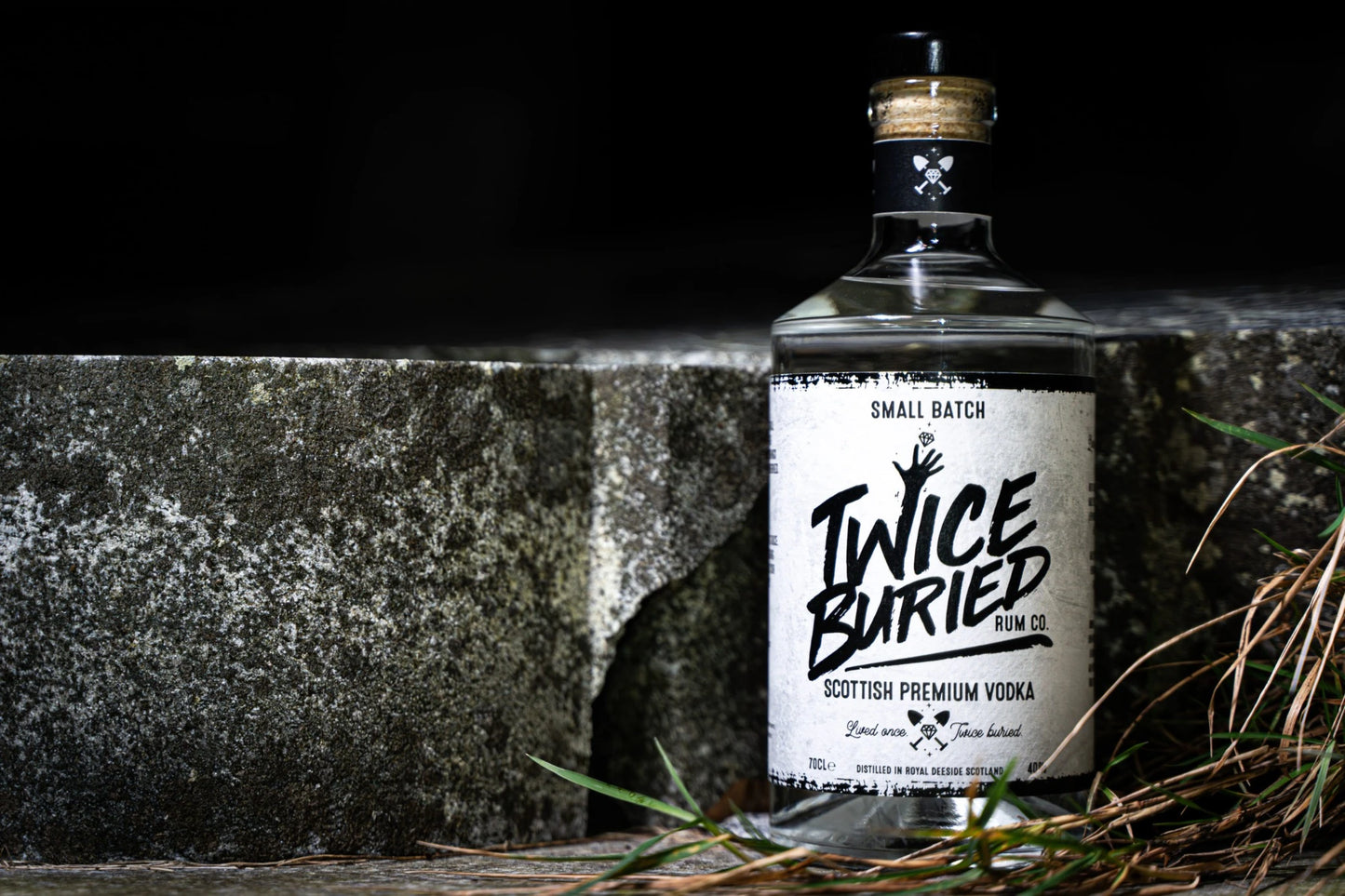 Twice Buried Scottish Vodka bottle against a dark grave backdrop